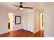 Bedroom with hardwood floors, closet space, and ceiling fan; bathroom is adjacent at 7808 The Esplanade Ct, Orlando, FL 32836