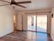 Bright bedroom with a ceiling fan and sliding glass doors to patio at 7808 The Esplanade Ct, Orlando, FL 32836