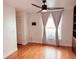 Bright bedroom with hardwood floors, a ceiling fan, and large windows with curtains at 7808 The Esplanade Ct, Orlando, FL 32836