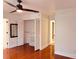 Bedroom with hardwood floors, closet space, and a ceiling fan for added comfort at 7808 The Esplanade Ct, Orlando, FL 32836