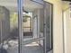 Exterior view of enclosed porch showing sink, cabinet, and screen door for indoor outdoor living at 7808 The Esplanade Ct, Orlando, FL 32836