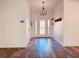 Inviting foyer features wood flooring, a stylish chandelier, and a glass paneled front door at 7808 The Esplanade Ct, Orlando, FL 32836