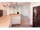 An open-concept kitchen features butcher block counters, stainless appliances, and modern light fixtures at 7808 The Esplanade Ct, Orlando, FL 32836