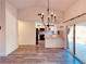 Open kitchen area with a breakfast bar, white cabinets, and stainless steel appliances at 7808 The Esplanade Ct, Orlando, FL 32836