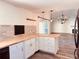 Bright, modern kitchen with sleek countertops and a view into the living room with a fireplace at 7808 The Esplanade Ct, Orlando, FL 32836