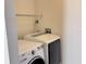 Functional laundry room with washer, dryer, and wire shelving for organized storage at 7808 The Esplanade Ct, Orlando, FL 32836
