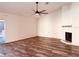 Spacious living room featuring a fireplace and a ceiling fan at 7808 The Esplanade Ct, Orlando, FL 32836