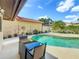 Relax and unwind by the sparkling pool with a seating area for outdoor dining at 7808 The Esplanade Ct, Orlando, FL 32836