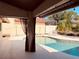 Backyard view of in-ground pool and patio area, complete with lounge chairs and lush landscaping at 7808 The Esplanade Ct, Orlando, FL 32836