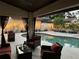 Relaxing patio with a view of the beautiful pool, complete with ambient string lights at 7808 The Esplanade Ct, Orlando, FL 32836