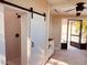 Enclosed porch with barn door access to shower, sink, and screened windows with a view to the outside at 7808 The Esplanade Ct, Orlando, FL 32836