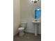 Half-bath showcasing pedestal sink, sleek fixtures, and modern tile flooring at 11015 Bostwick Aly, Winter Garden, FL 34787