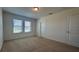 Bright bedroom with natural light from two windows, carpet, and closet at 11015 Bostwick Aly, Winter Garden, FL 34787