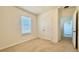 Well-lit bedroom features neutral carpet, a window with blinds, and a closet at 11015 Bostwick Aly, Winter Garden, FL 34787