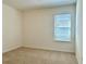 Cozy bedroom featuring neutral carpet and a window with blinds at 11015 Bostwick Aly, Winter Garden, FL 34787