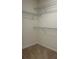 Walk-in closet offering ample storage with wire shelving and neutral carpet flooring at 11015 Bostwick Aly, Winter Garden, FL 34787