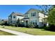 Street view showcasing well-maintained two-story homes with green lawns under a clear blue sky at 11015 Bostwick Aly, Winter Garden, FL 34787