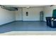 Clean and organized garage interior with painted walls and epoxy floor, great for storage and projects at 11015 Bostwick Aly, Winter Garden, FL 34787