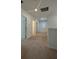 Upstairs hallway featuring neutral carpet, white doors, a window, and recessed lighting at 11015 Bostwick Aly, Winter Garden, FL 34787