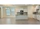 Modern kitchen with white cabinets, granite countertops and island with sink at 11015 Bostwick Aly, Winter Garden, FL 34787
