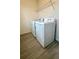 Laundry room features a washer, dryer, wire shelving and tile floor at 11015 Bostwick Aly, Winter Garden, FL 34787