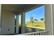 Picturesque porch view of a lush green lawn and trees under a clear blue sky at 11015 Bostwick Aly, Winter Garden, FL 34787