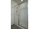 Modern walk-in shower featuring a glass enclosure, clean white tile, and updated shower fixtures at 11015 Bostwick Aly, Winter Garden, FL 34787
