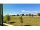 Scenic view from window overlooking green space, trees, and street at 11015 Bostwick Aly, Winter Garden, FL 34787