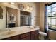 Bathroom featuring double sinks with a large mirror and a glass shower stall at 11041 Se 169Th Pl, Summerfield, FL 34491
