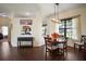 Dining area with a modern chandelier, large windows and comfortable seating at 11041 Se 169Th Pl, Summerfield, FL 34491