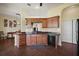 Well-equipped kitchen with wooden cabinets, stainless steel appliances, and a breakfast bar at 11041 Se 169Th Pl, Summerfield, FL 34491