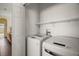 Laundry room featuring a modern washing machine and dryer with shelving at 11041 Se 169Th Pl, Summerfield, FL 34491