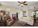 Comfortable living room with a ceiling fan, neutral colored walls, and tile floors at 11041 Se 169Th Pl, Summerfield, FL 34491