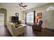 Spacious living room featuring tile floors, large windows, a ceiling fan, and comfortable seating at 11041 Se 169Th Pl, Summerfield, FL 34491