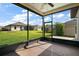 The screened-in patio offers beautiful views of the expansive backyard at 11041 Se 169Th Pl, Summerfield, FL 34491