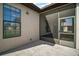An outdoor patio area features a screened enclosure and is adjacent to a window and stucco wall at 11041 Se 169Th Pl, Summerfield, FL 34491