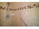 Close-up of the shower with neutral tiles and a hand-held shower head at 11041 Se 169Th Pl, Summerfield, FL 34491