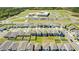Aerial view of new construction neighborhood featuring well-maintained lawns and a nearby school at 1179 Tyler Loop, Winter Haven, FL 33884