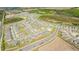 Aerial view showcasing community layout with homes and winding roads in an expansive suburban setting at 1179 Tyler Loop, Winter Haven, FL 33884