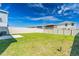 Spacious backyard with a white fence and green grass, perfect for outdoor activities and relaxation at 1179 Tyler Loop, Winter Haven, FL 33884