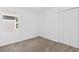 Carpeted bedroom with a window and closet doors at 1179 Tyler Loop, Winter Haven, FL 33884