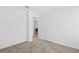 Bright bedroom with neutral carpet and doorway to the laundry room at 1179 Tyler Loop, Winter Haven, FL 33884