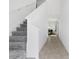 Bright entryway featuring neutral flooring, carpeted stairs, and white walls for a modern and clean look at 1179 Tyler Loop, Winter Haven, FL 33884