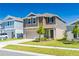 Two-story home showcasing manicured lawn and attached two car garage with driveway at 1179 Tyler Loop, Winter Haven, FL 33884