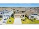 Beautiful two-story home featuring a manicured lawn and a two car attached garage at 1179 Tyler Loop, Winter Haven, FL 33884