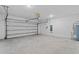 Spacious two-car garage with an automatic door and concrete flooring at 1179 Tyler Loop, Winter Haven, FL 33884