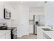Modern kitchen with stainless steel appliances, white cabinetry, and a sleek design for cooking convenience at 1179 Tyler Loop, Winter Haven, FL 33884