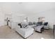 Open-concept living area featuring a large sectional sofa and neutral tile floors for a bright and airy feel at 1179 Tyler Loop, Winter Haven, FL 33884