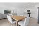 Open-concept living space featuring a dining table, living room, and modern kitchen for entertaining at 1179 Tyler Loop, Winter Haven, FL 33884