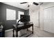 Cozy bedroom with decorative gray accent wall, carpet, and large black desk at 12180 Sonnet Ave, Orlando, FL 32832